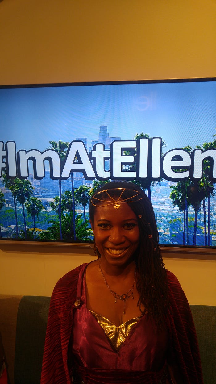 The author, Roxanne Joseph standing in front of a hashtag “I’m At Ellen” sign